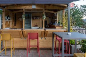 an outdoor kitchen with two chairs and a table at Al Casolare in Ofena