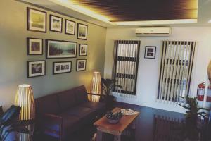 a living room with a couch and a table at Alchan Suites in General Santos +25 photos