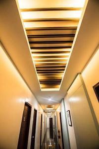 a hallway in an airplane with a ceiling at Alchan Suites in General Santos