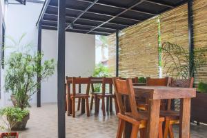 a dining room with a wooden table and chairs at Alchan Suites in General Santos