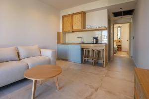 a living room with a couch and a table at Thines Comfort Living in Nea Peramos