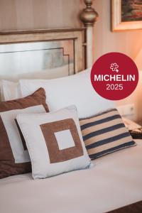 a white bed with brown and white pillows on it at Esplanade Zagreb Hotel in Zagreb +249 photos