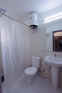 a bathroom with a toilet and a sink at Supremo Home Stays in Agra +22 photos