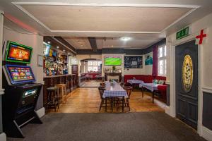 a dining room with a table and a video game at The Stag and Hen Pub in Coventry
