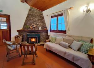 a living room with a couch and a fireplace at Casa do Rio, Natureza - Nova Gestão in Melgaço +61 photos