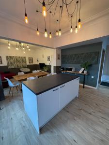 a large room with a kitchen and dining room at Duplex dans le centre d'Heusy in Verviers