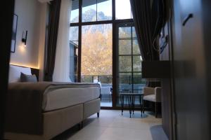 a hotel room with a bed and a large window at 1921 justa sefa otel in Amasya