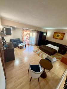a large living room with a couch and a table at Kornilios Istron Hotel in Giannitsa