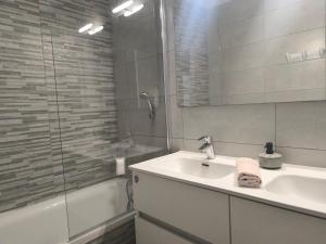 a white bathroom with a sink and a shower at Тhree bedroom house "TEA" -with garage close to the sea -SLIEMA in Sliema +62 photos