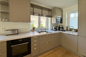 a kitchen with a sink and a microwave at Engels Hüs in Tinnum +18 photos