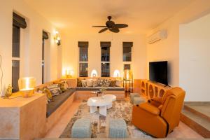 a living room with a couch and a tv at Casa Mandala by ELIVAAS in Candolim