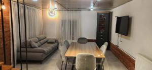 a living room with a table and a couch at Harmony house in Bakuriani