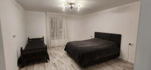 a bedroom with a bed and a ceiling fan at Harmony house in Bakuriani
