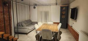 a living room with a table and a couch at Harmony house in Bakuriani