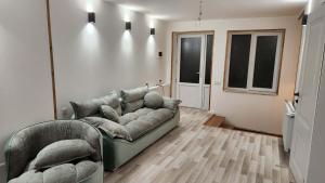 a living room with a couch and two chairs at Harmony house in Bakuriani +3 photos