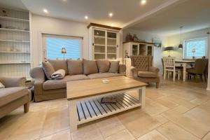 a living room with a couch and a table at Ferienhaus Eibenweg 6 in Tinnum