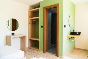 a room with green and white walls and a door at Maui Poolside Studios in Laganas