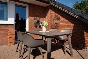 a table and chairs sitting on a patio at Instenweg 14 Sternhus in Rettin +45 photos