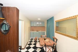 a dining room with a table and a mirror at Two bedroom Vintage apartment in Kotor