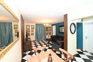a living room with a black and white checkered floor at Two bedroom Vintage apartment in Kotor