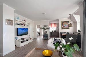 a living room with a couch and a tv at Wohnung 9 in Westerland