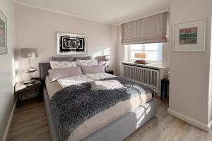 a bedroom with a large bed and a window at Wohnung 9 in Westerland +4 photos