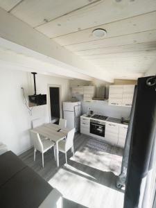a kitchen with a table and chairs in a room at VILLAGGIO TURISTICO LA FOCE SpA in Toscolano Maderno