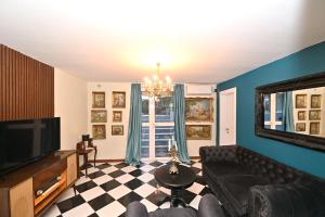 a living room with a couch and a television at Two bedroom Vintage apartment in Kotor