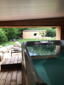 a swimming pool on a deck next to a house at Natur eau Bulle in Ploufragan
