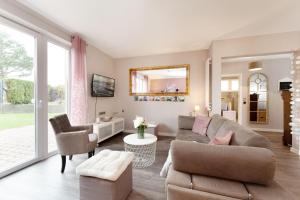 a living room with a couch and a chair at Instenweg 14 Fischhus in Rettin +49 photos