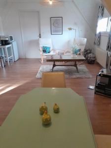 a living room with a table and a couch at Les Tilleuls in Prayssac +3 photos