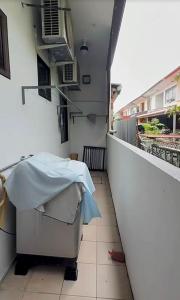 a balcony with a table with a blanket on it at Easy stay kk in Kota Kinabalu