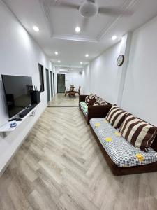 a living room with a couch and a flat screen tv at Easy stay kk in Kota Kinabalu