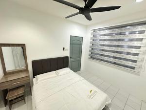 a bedroom with a bed and a ceiling fan at Easy stay kk in Kota Kinabalu