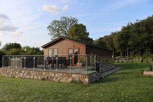 a tiny house on a stone wall in a field at Holly Lodge in Holywell