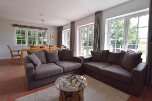 a living room with a couch and a table at Ferienhaus Helen in Morsum