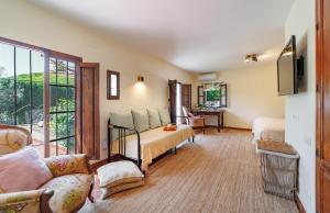 a living room with a bed and a couch at Sierra Blanca Bungalow in Marbella