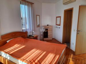 a bedroom with a bed and a fan in it at Villa Jasmin in Aheloy