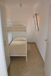 a small room with two bunk beds and a hallway at Residence Conca Blue in Conca