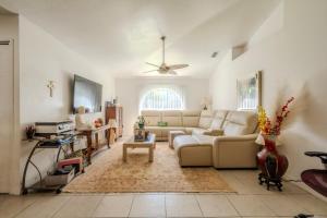 a living room with a couch and a ceiling fan at Flint and Kingscrest, LLC - Private Rooms in Shared Home in Orlando