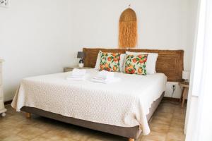 a bedroom with a large bed with white sheets and pillows at Oura Parque Apartamentos Turisticos in Albufeira +128 photos