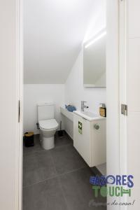 a bathroom with a toilet and a sink at Casa Menino do Mar in Porto Judeu +31 photos