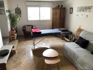 a living room with a couch and a dog bed at Natur eau Bulle in Ploufragan