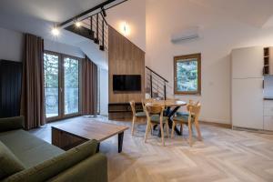 a living room with a table and a couch at Apartamenty Beski in Szczyrk