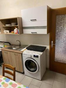 a kitchen with a washing machine and a sink at B&B LOKEV Lipica HostelSezana in Lokev