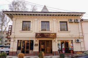 a building on a city street with a store at Gold Camel Registan in Samarkand