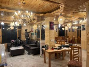 a living room with a man standing in the middle of it at Liora Stays in Palchān