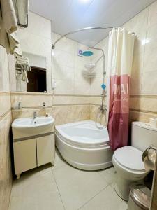a bathroom with a toilet and a sink and a shower at Gold Camel Registan in Samarkand +47 photos