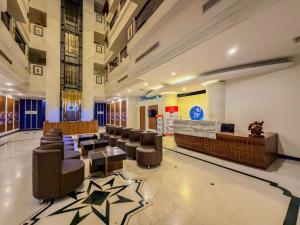 a lobby of a hotel with chairs and a waiting room at Zip By Spree Hotels Surabi International Vellore in Vellore