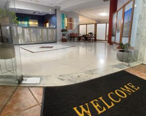 a lobby with a welcome sign on the floor at Kornilios Istron Hotel in Giannitsa